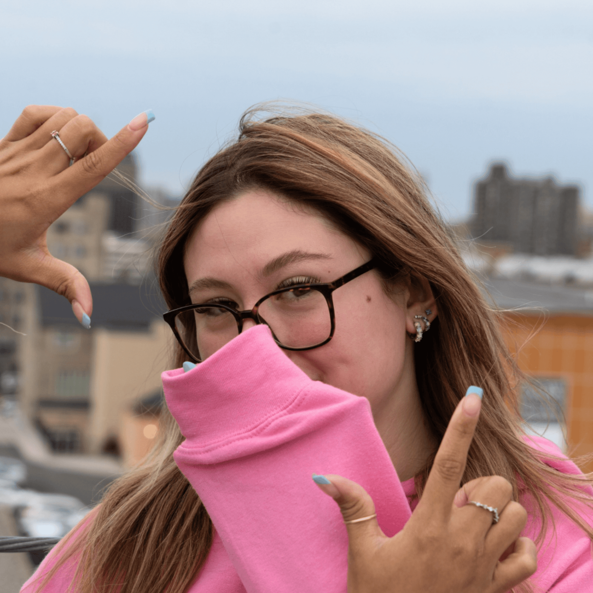 Stylish woman wearing a pink hoodie with essential oil infusion for mood enhancement and scent enrichment